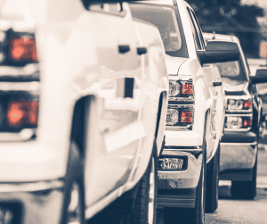 Three pickup trucks parked in a line.